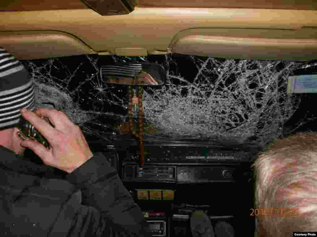 A car caught in the melee outside the prison has a shattered window reportedly broken by a police baton.