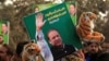 FILE: A supporter of the ruling Pakistan Muslim League Nawaz (PML-N) holds a picture of Nawaz Sharif