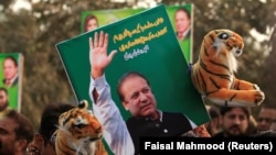 FILE: A supporter of the ruling Pakistan Muslim League Nawaz (PML-N) holds a picture of Nawaz Sharif