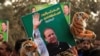 FILE: A supporter of the ruling Pakistan Muslim League (Nawaz) (PML-N) holds a picture of Nawaz Sharif outside the accountability court hearing corruption cases against him.