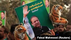 A supporter of the ruling Pakistan Muslim League (Nawaz) (PML-N) holds a picture of Nawaz Sharif outside the accountability court where he appeared on November 3.