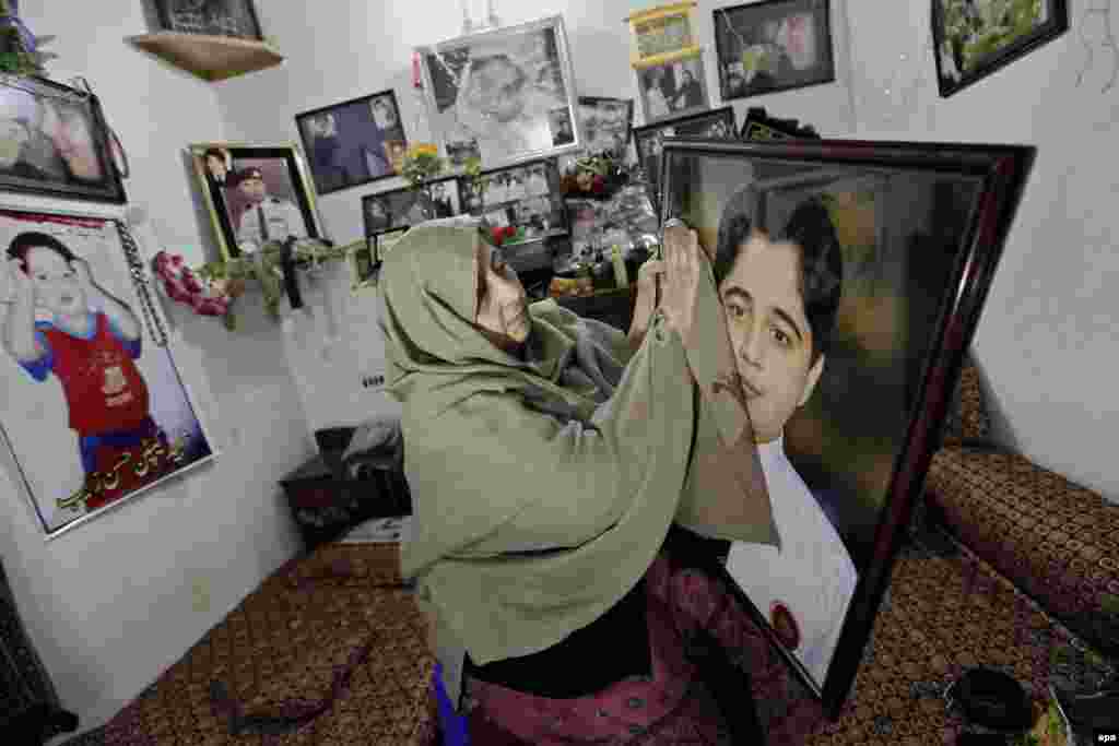 Nasra Zeb is pictured in her late son's room with his belongings on December 14, 2015. Hasan Zeb was one of the 132 students of the Army Public School killed by Taliban militants in Peshawar, Pakistan, on December 16, 2014. (epa/Arshad Arbab)