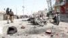 Police officers inspect the scene of a bomb blast in the border town of Chaman in the southwestern province of Balochistan on August 10.