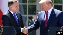 U.S. President Donald Trump (right) and Polish President Andrzej Duda shake hands after holding a joint press conference in the Rose Garden of the White House in Washington on June 12.