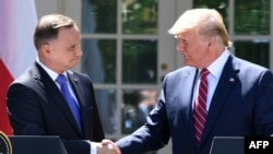 U.S. President Donald Trump (right) and Polish President Andrzej Duda shake hands after holding a joint press conference at the White House in Washington, D.C., on June 12.