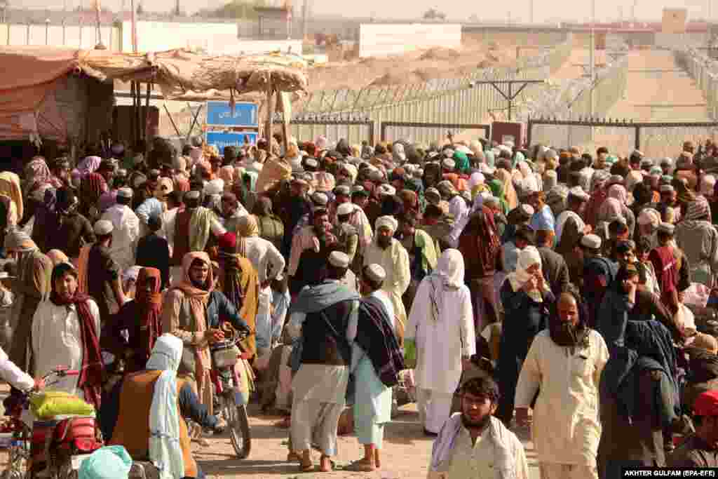 People stranded at the Pakistani-Afghan border wait for its reopening after it was closed by the Taliban after militants took over control of the Afghan side of the border at Chaman, Pakistan.