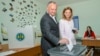 Moldovan President Igor Dodon (left) casts his ballot with his wife at a polling station during local elections in Chisinau on May 20.