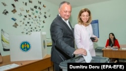 Moldovan President Igor Dodon (left) casts his ballot with his wife at a polling station during local elections in Chisinau on May 20.