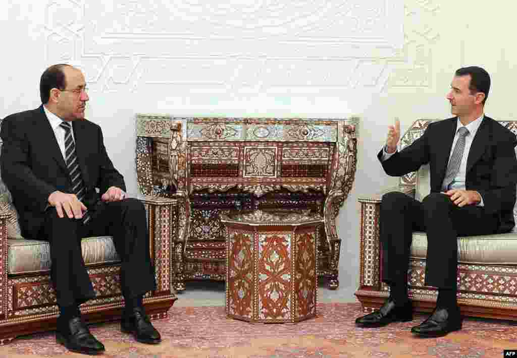 Syria -- President Bashar al-Assad (R) meets with Iraqi Prime Minister Nuri al-Maliki in Damascus, 13Oct2010 - SYRIA, Damascus : A picture released by the Syrian News Agency SANA shows Syrian President Bashar al-Assad (R) meeting with Iraqi Prime Minister Nuri al-Maliki at al-Shaab palace in Damascus, on October 13, 2010. AFP PHOTO/HO/SANA ==RESTRICTED TO EDITORIAL USE== 