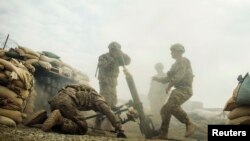 FILE: U.S. soldiers from the 3rd Cavalry Regiment fire a 120mm mortar during an exercise on forward operating base Gamberi in the Laghman province in December 2014.