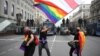 LGBT activists wave a rainbow and an old Belarusian flag during an anti-government rally in Minsk in September 2020.