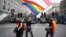 LGBT activists wave a rainbow and an old Belarusian flag during an anti-government rally in Minsk in September 2020.
