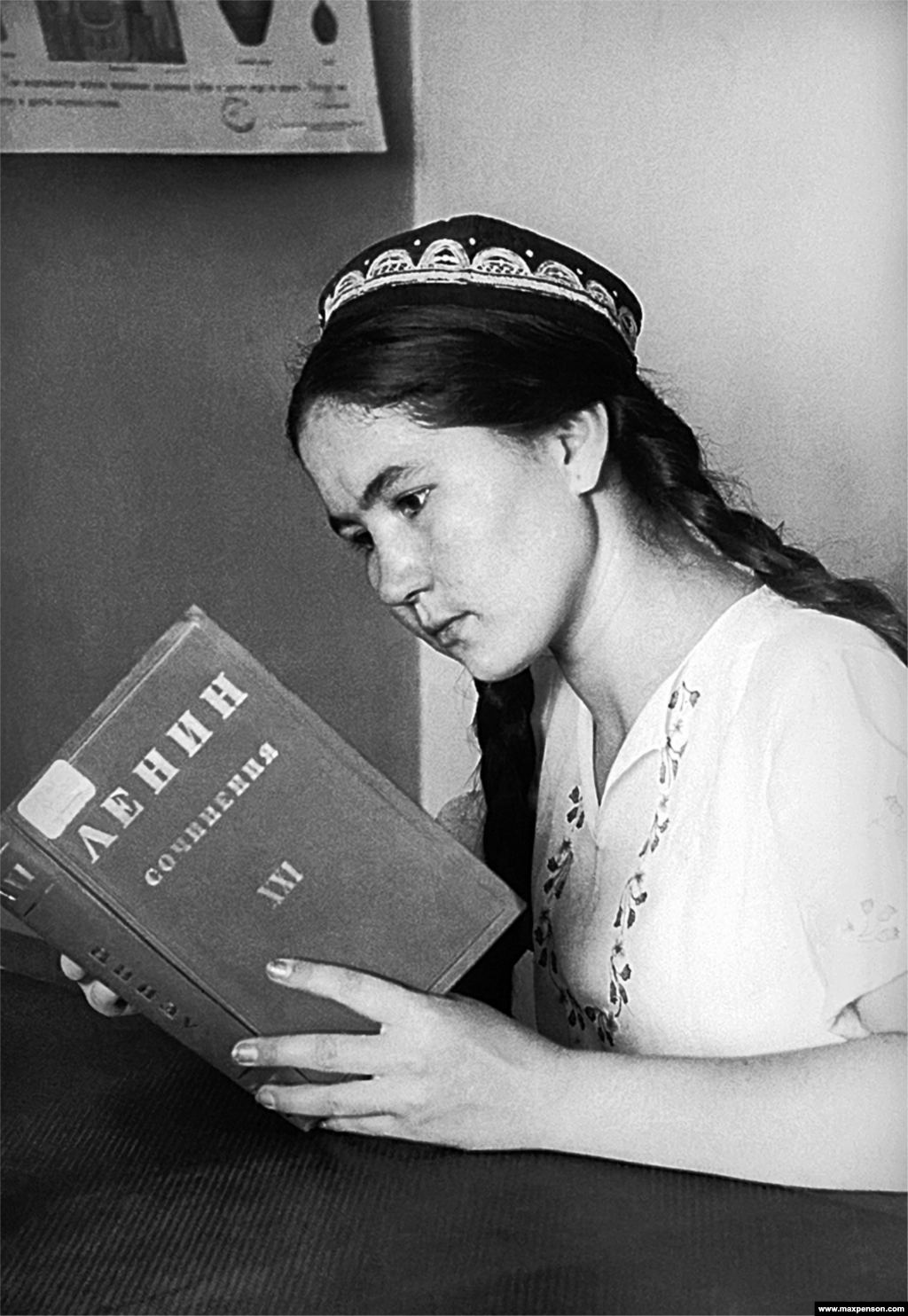 A stern-faced young Uzbek girl reading one of Lenin&#39;s tomes.