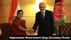 Afghan President Ashraf Ghani (right) shakes hands with External Affairs Minister Sushma Swaraj in New Delhi on October 24.