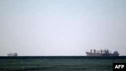 Oil tankers cruise out of the Strait of Hormuz, which Iran has threatened to shut. 