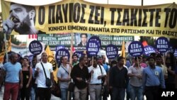 Greek protesters hold a banner featuring a picture of the antifascist rapper Pavlos Fyssas who was murdered by an alleged Golden Dawn member on September 17. 