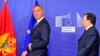 European Commission President Jose Manuel Barroso (R) welcomes Prime Minister of Montenegro Milo Dukanovic prior to a working session at the European Union headquarters in Brussels, 21Jan2013