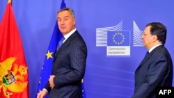 European Commission President Jose Manuel Barroso (R) welcomes Prime Minister of Montenegro Milo Dukanovic prior to a working session at the European Union headquarters in Brussels, 21Jan2013