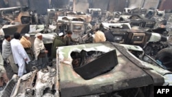 Burned-out trucks at a NATO terminal outside the city of Peshawar on Demember 7.