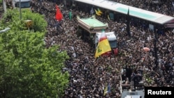 Mourners attend the funeral for victims of the helicopter crash that killed Iran's President Ebrahim Raisi, Foreign Minister Hossein Amir-Abdollahian, and others, in Tehran on May 22.