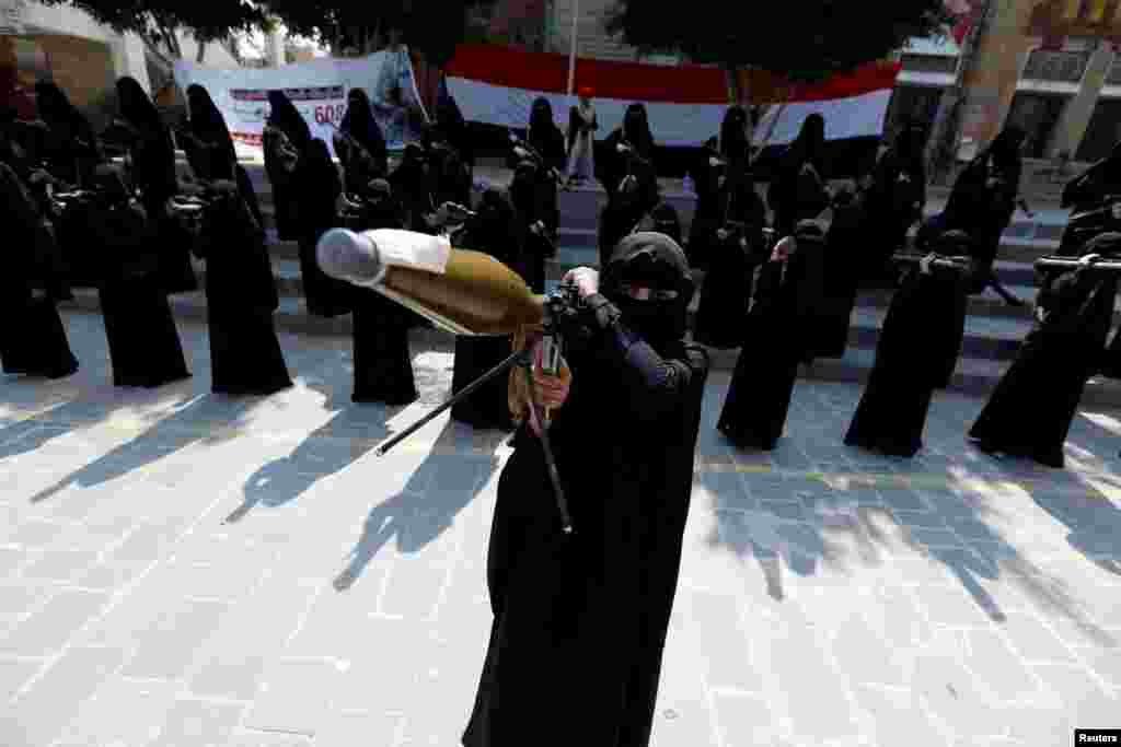 A woman loyal to the Houthi movement holds a rocket-propelled grenade launcher as she takes part in a parade to show support for the movement in Sanaa, Yemen. (Reuters/Khaled Abdullah)