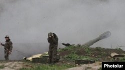 Karabakh Armenian troops fire rounds from a howitzer in the Martakert district of the breakaway rgion in early April.
