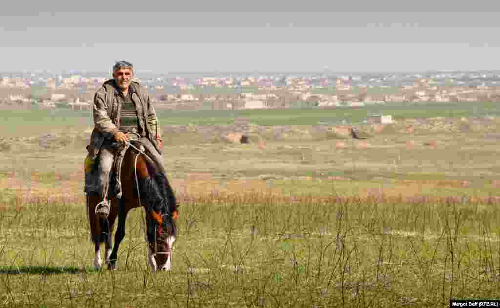 A horseman rides near the remains of the town of Agdam. During the war, some 40,000 Azerbaijanis were driven out of the town, which was reduced to rubble by Armenian forces.