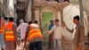 Pakistani volunteers collect debris from a demolished Ahmadi mosque in the eastern city of Sialkot on May 24.