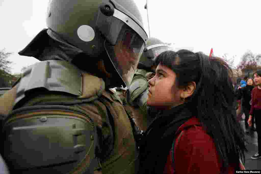 A demonstrator stares down a riot policeman during a protest marking the country&#39;s 1973 military coup in Santiago. (Reuters/Carlos Vera)