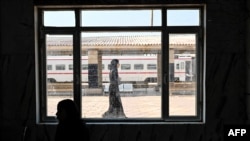 Shi'ite pilgrims wait in the Basra railway station to take the train to the shrine city of Karbala on August 19. 