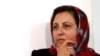 Shirin Ebadi (center) speaks to journalists as she leaves the Center of Human Rights Defenders after Iranian police closed its doors on December 21.