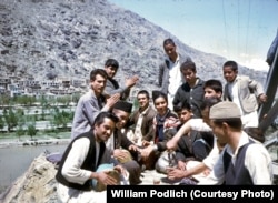 Young Afghans gather to share tea, sing, and play music.