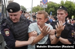 Aleksei Navalny is detained during a rally in Moscow in June.