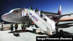 Saudi players leave their Rossiya Airbus A319 after a tense landing in Rostov-on-Don on June 19.