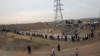 Students form a human chain during a protest to defend Iran's nuclear program outside the Fordow Uranium Conversion Facility in Qom, in the north of the country, November 19, 2013