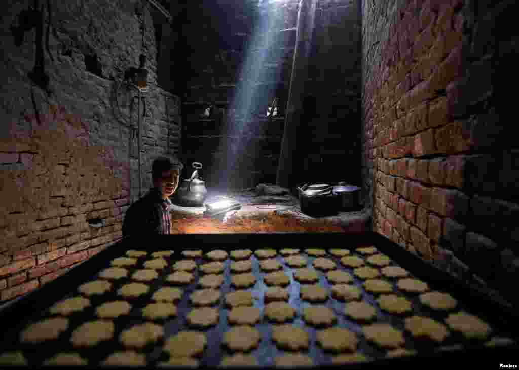 An Afghan man makes sweets at a small traditional factory during the holy Muslim fasting month of Ramadan in preparation for Eid. (Reuters/Omar Sobhani)