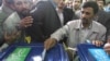 Happier days? Iranian President Mahmud Ahmadinejad (right) casts his vote at a polling station during previous parliamentary elections in 2008. 