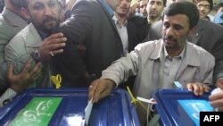 Happier days? Iranian President Mahmud Ahmadinejad (right) casts his vote at a polling station during previous parliamentary elections in 2008. 