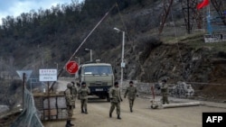 Azerbaijani soldiers patrol at a checkpoint outside the town of Susa. (file photo)