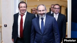 Armenia - Prime Minister Nikol Pashinian (C) arrives for a business forum organized by Gagik Tsarukian (L), October 26, 2018.