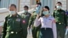 Myanmar - The military-appointed members of parliament wearing face masks amid fears about the spread of the COVID-19 novel coronavirus leave after a session in Naypyidaw on March 4, 2020. - Myanmar's military still plays a powerful role in the country's 