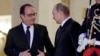 French President Francois Hollande (left) shakes hands with Russian President Vladimir Putin after a summit on the Ukraine crisis at the Elysee Palace in Paris, France, on October 2.