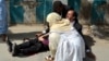 A doctor treats an injured lawyer at the scene of a suicide attack in the southwestern Pakistani city of Quetta. The August 8 attack killed 75 people. Most victims were lawyers.