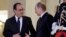 French President Francois Hollande (left) shakes hands with Russian President Vladimir Putin after a summit on the Ukraine crisis at the Elysee Palace in Paris, France, on October 2.