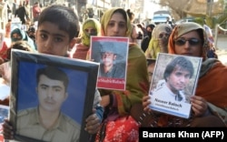 Relatives of Baloch victims of enforced disappearances hold pictures of their loved ones in a demonstration during Human Rights Day in Quetta, the capital city of southwestern Balochistan Province on December 10.