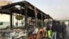 Iranians inspect the wreckage of a bus that was set ablaze by protesters during a demonstration against a rise in gasoline prices in the central city of Isfahan, November 17, 2019