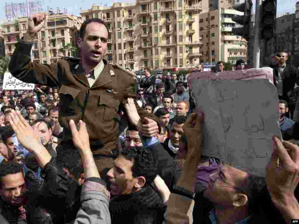 An army officer joins the demonstrators in Cairo's central Tahrir Square.