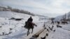 A horseman sets off to take part in the Uzbek national game &quot;kopkari.&quot;