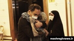 Iranian scientist Sirous Asgari (left) is greeted upon his arrival home from the United States on June 3.