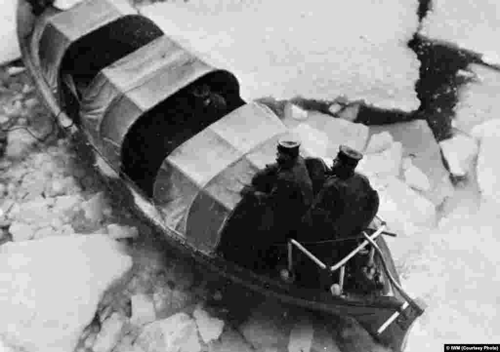 A motorboat from the &quot;HMS Trumpeter&quot; works its way through ice after the carrier&#39;s arrival at Kola Inlet.